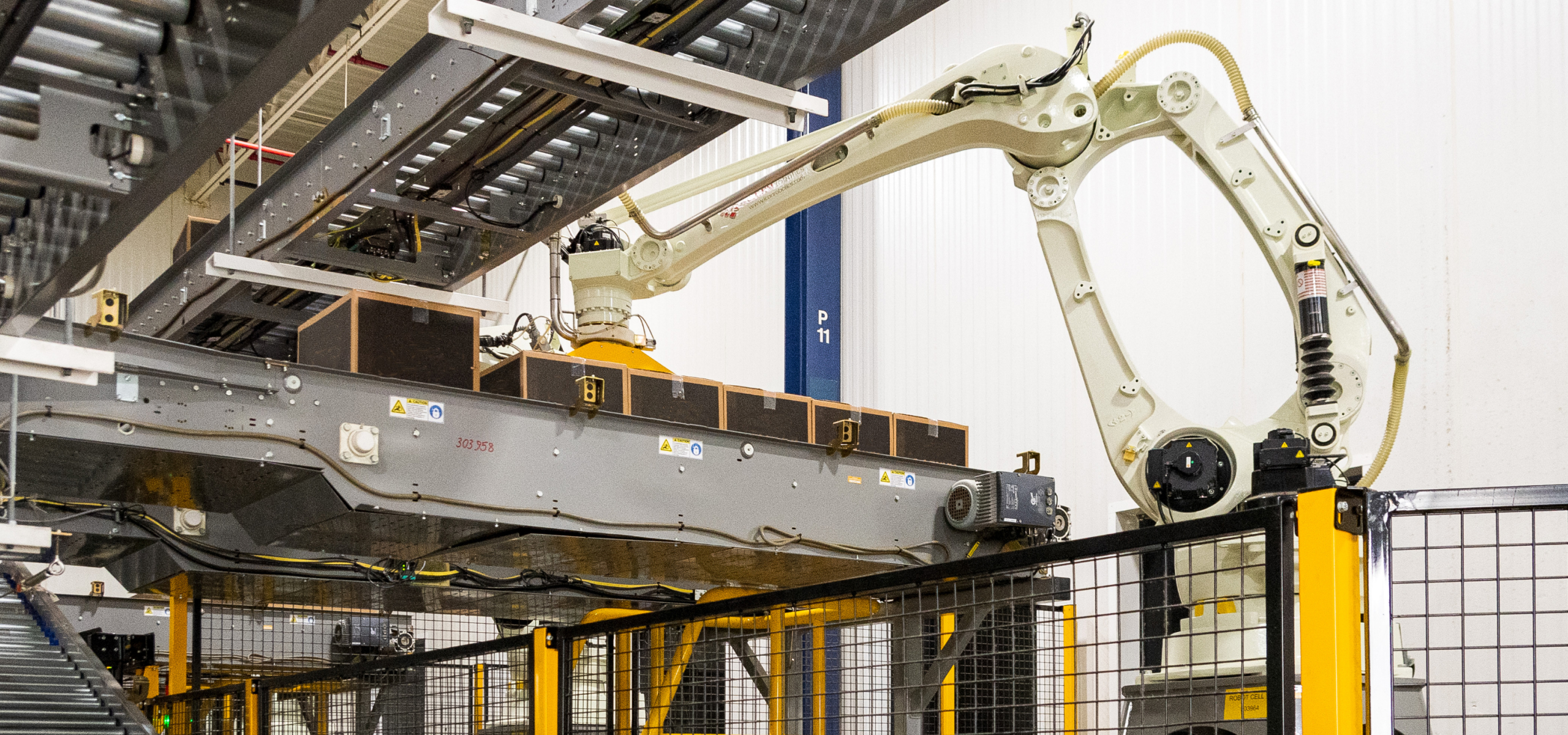 Robotic arm moving boxes on the factory floor